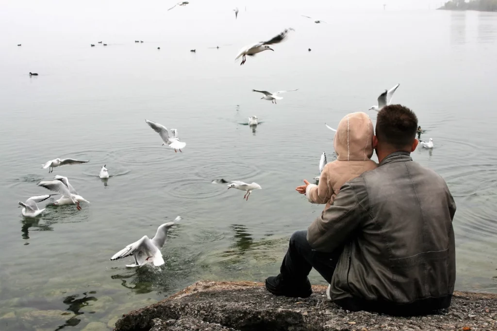 The Stork Bag - Superdaddy 5 Reasons Why Daddies Are The Real Supermen - father and child sitting in front of a pond