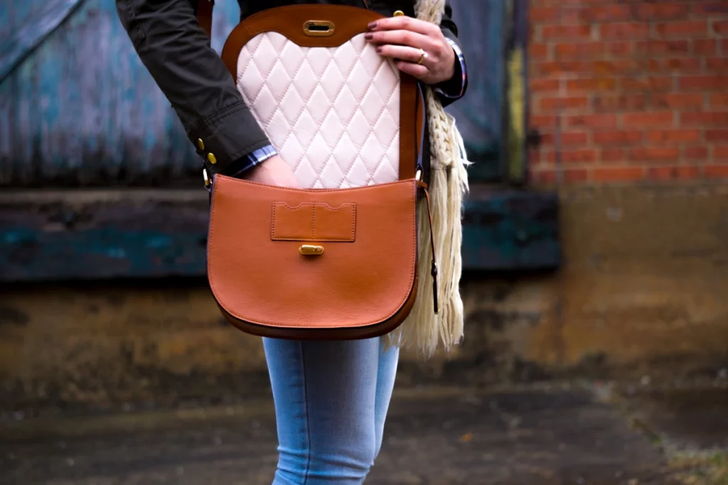 the stork bag - Favorite Items To Keep In Your Handbag When Youre Expecting - woman holding purse